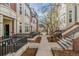 Exterior view of the townhome community, featuring landscaped walkways and beautiful architecture at 30 Garfield St # G, Denver, CO 80206