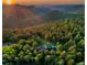 Majestic mountain home surrounded by dense green forests and breathtaking views, highlighted by a sunset at 13416 Kuehster Rd, Littleton, CO 80127