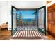 Inviting balcony view through open french doors showcasing the scenic landscape and beautiful clear blue skies at 13416 Kuehster Rd, Littleton, CO 80127