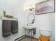 Charming bathroom with pedestal sink, decorative mirror, and artwork creating a welcoming space at 13416 Kuehster Rd, Littleton, CO 80127