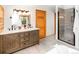 Well-appointed bathroom with double vanity, shower, modern fixtures, and ample storage space at 13416 Kuehster Rd, Littleton, CO 80127