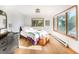 Light-filled bedroom with hardwood floors and large windows offering views of nature at 13416 Kuehster Rd, Littleton, CO 80127