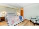 Comfortable bedroom with stylish decor, wood floors, sconce lighting, and a cozy sitting area at 13416 Kuehster Rd, Littleton, CO 80127