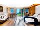 Bright bedroom featuring a murphy bed, foosball table, and large windows overlooking an idyllic landscape at 13416 Kuehster Rd, Littleton, CO 80127