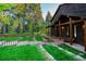 Inviting mountain home with covered porch, featuring stone accents and a beautifully landscaped yard at 13416 Kuehster Rd, Littleton, CO 80127
