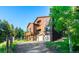 Spacious multi-story home with multiple decks, a two-car garage, and a large yard surrounded by trees at 13416 Kuehster Rd, Littleton, CO 80127