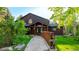 Charming home featuring a stone pathway and lush landscaping with a rustic, welcoming entrance at 13416 Kuehster Rd, Littleton, CO 80127