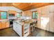 Charming kitchen features wood cabinets, granite countertops, and a large island with seating at 13416 Kuehster Rd, Littleton, CO 80127