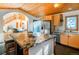 Open kitchen with wood cabinets, granite countertops, and a view of the living room at 13416 Kuehster Rd, Littleton, CO 80127