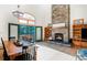 Bright living room with wood floors and a stone fireplace, complemented by scenic views, creates a cozy ambiance at 13416 Kuehster Rd, Littleton, CO 80127