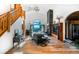 Spacious living room featuring a stone fireplace, high ceilings, wood floors, and abundant natural light, perfect for entertaining at 13416 Kuehster Rd, Littleton, CO 80127