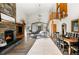 Bright, open living room featuring a stone fireplace, wood floors, and vaulted ceilings at 13416 Kuehster Rd, Littleton, CO 80127