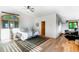 Bright primary bedroom with arched window, light hardwood floors, and a cozy rug, creating a relaxing space at 13416 Kuehster Rd, Littleton, CO 80127