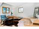 Bright and airy office space with wood floors, a unique desk, and large windows offering scenic views at 13416 Kuehster Rd, Littleton, CO 80127
