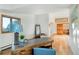 Well-lit office featuring wood floors, rustic wood desk, and a comfortable seating area at 13416 Kuehster Rd, Littleton, CO 80127