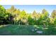 Beautiful wooded property featuring a fire cistern for safety and lush green trees at 13416 Kuehster Rd, Littleton, CO 80127