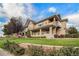 Charming multi-level townhouse with stone accents, white picket fence, manicured lawn, and beautiful landscaping at 10818 Cimarron St # 1202, Firestone, CO 80504