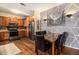 Modern kitchen featuring stainless steel appliances, stylish backsplash, and an adjacent dining area at 10818 Cimarron St # 1202, Firestone, CO 80504