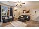 Inviting living room featuring large windows, neutral walls, modern ceiling fan, and comfortable furnishings at 10818 Cimarron St # 1202, Firestone, CO 80504