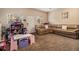 Large playroom features a comfortable seating area and dedicated ' space, perfect for Gathering fun at 10818 Cimarron St # 1202, Firestone, CO 80504