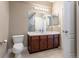 The bathroom features a large vanity with white countertops, a toilet, and a large mirror at 6265 S Ider Way, Aurora, CO 80016