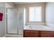 Bright bathroom featuring a shower, bathtub, and large window that allows natural light at 6265 S Ider Way, Aurora, CO 80016
