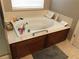 Comfortable soaking tub with tile surround and mounted faucet, perfect for relaxation and rejuvenation at 6265 S Ider Way, Aurora, CO 80016