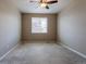 Bedroom with neutral walls, carpet, ceiling fan and window overlooking a tree at 6265 S Ider Way, Aurora, CO 80016