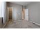 Neutral, carpeted bedroom featuring a walk-in closet and a door leading to another room at 6265 S Ider Way, Aurora, CO 80016