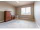 A light-filled bedroom showcases neutral walls, carpet, and a window with bright natural light at 6265 S Ider Way, Aurora, CO 80016