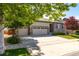 Inviting home exterior featuring a three-car garage and attractive landscaping on a sunny day at 6265 S Ider Way, Aurora, CO 80016