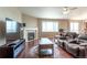 Spacious living room with a fireplace, large TV, and access to a deck at 6265 S Ider Way, Aurora, CO 80016