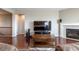 Comfortable living room featuring a fireplace, media center, and hardwood floors at 6265 S Ider Way, Aurora, CO 80016