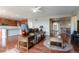 Open-concept living area featuring hardwood floors, a cozy seating area, and an adjacent kitchen at 6265 S Ider Way, Aurora, CO 80016