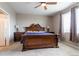 Elegant primary bedroom with a large bed, side tables, and a window at 6265 S Ider Way, Aurora, CO 80016