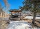 Backyard with gazebo, picnic table, and snowy ground at 5191 S Pennsylvania St, Littleton, CO 80121