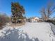 Large backyard with snow, and a view of the house at 5191 S Pennsylvania St, Littleton, CO 80121