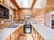 Retro kitchen with wood cabinets and brick backsplash at 5191 S Pennsylvania St, Littleton, CO 80121