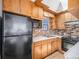 Retro kitchen with wood cabinets and brick backsplash at 5191 S Pennsylvania St, Littleton, CO 80121