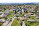 An aerial view showing homes in a well-spaced neighborhood with mature trees and expansive green lawns at 2837 Reed St, Wheat Ridge, CO 80033