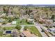An aerial view of neighborhood with mature trees, well-kept lawns, swimming pools, and proximity to the cityscape at 2837 Reed St, Wheat Ridge, CO 80033