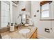 Bathroom featuring a granite countertop vanity, decorative orchids, and a window with wood blinds at 2837 Reed St, Wheat Ridge, CO 80033
