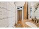 Bathroom showcasing a vanity with a granite countertop, shower with patterned curtain, and tile flooring at 2837 Reed St, Wheat Ridge, CO 80033