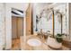 Bathroom featuring a granite countertop vanity with white orchids and a view into the hallway at 2837 Reed St, Wheat Ridge, CO 80033