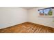 Bright bedroom with hardwood floors and natural light from the window at 2837 Reed St, Wheat Ridge, CO 80033