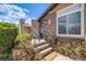 Inviting front entrance with brick facade, stone accents, and a welcoming entrance mat at 2837 Reed St, Wheat Ridge, CO 80033
