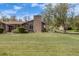 Charming home with a well-manicured lawn and beautiful stone chimney, offering great curb appeal at 2837 Reed St, Wheat Ridge, CO 80033