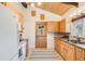 Bright kitchen with wooden cabinets, granite countertops, stainless steel sink, and white appliances at 2837 Reed St, Wheat Ridge, CO 80033