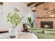 Cozy living room featuring a stone fireplace, plants and stylish decor at 2837 Reed St, Wheat Ridge, CO 80033