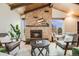 Bright living room showcasing a stone fireplace, vaulted ceilings, and modern decor and furnishings at 2837 Reed St, Wheat Ridge, CO 80033